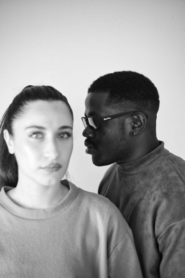 Black and white photo featuring a man and woman in soft focus and depth perspective.